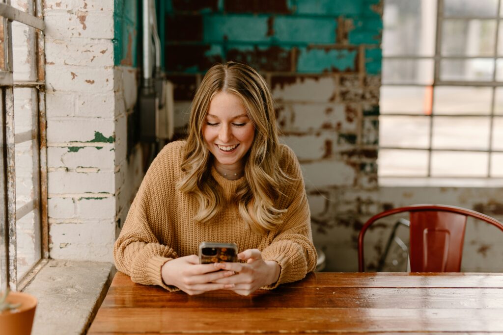 Woman smiling at phone