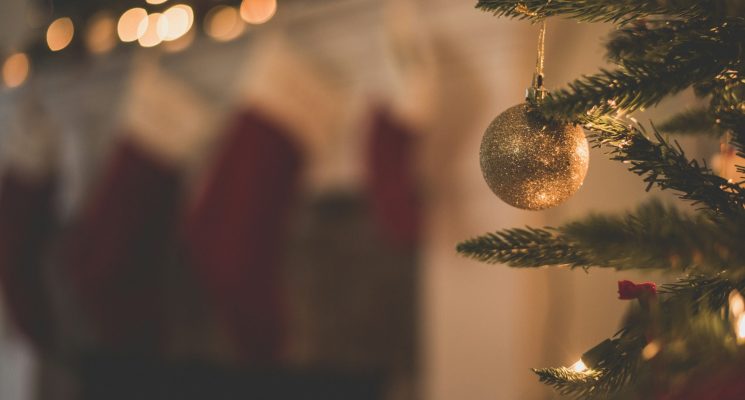 Christmas tree with stockings in the background