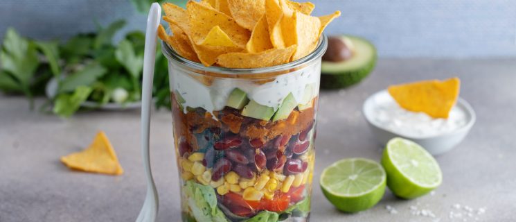 Healthy mexican style lunchbox to go in glass on table.